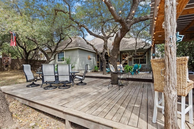wooden terrace featuring outdoor dining space and fence