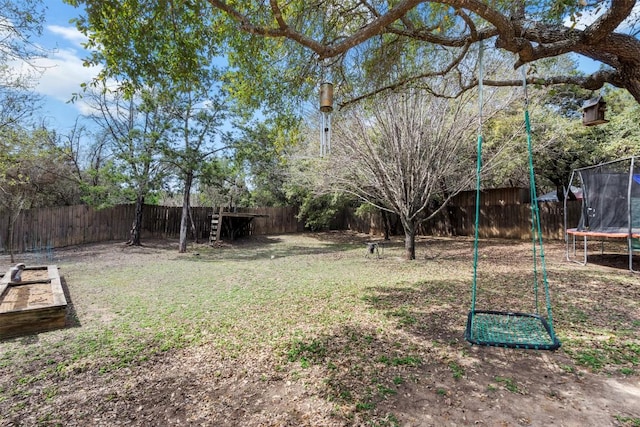 view of yard with a fenced backyard and a trampoline