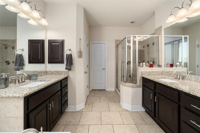 100 Adorno Ln, Georgetown, TX 78628 - bathroom with a stall shower, two vanities, and tile patterned flooring