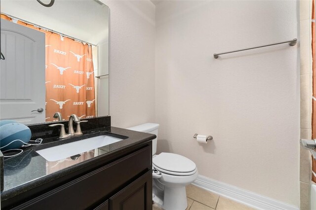 100 Adorno Ln, Georgetown, TX 78628 - bathroom with tile patterned flooring, toilet, vanity, baseboards, and a shower with shower curtain
