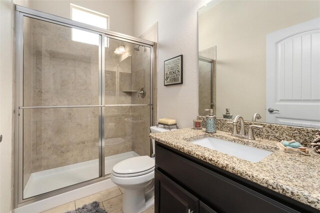 100 Adorno Ln, Georgetown, TX 78628 - bathroom with toilet, vanity, a shower stall, and tile patterned flooring