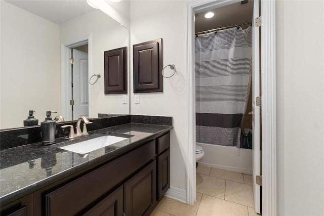 100 Adorno Ln, Georgetown, TX 78628 - bathroom featuring vanity, toilet, tile patterned floors, shower / bathtub combination with curtain, and baseboards