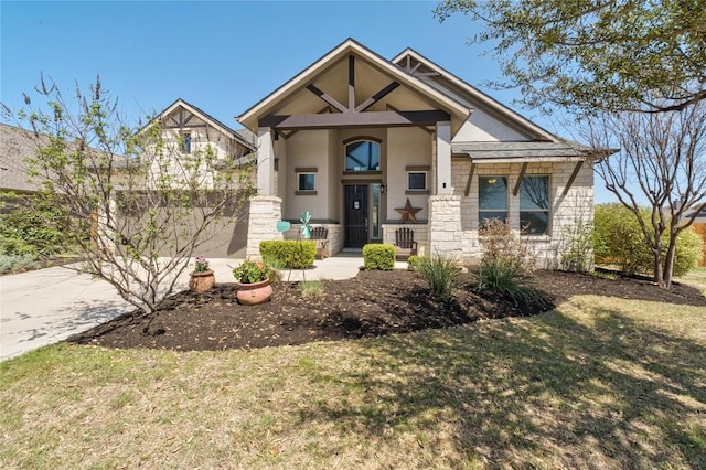 100 Adorno Ln, Georgetown, TX 78628 - view of front of house featuring stucco siding, concrete driveway, stone siding, a garage, and a front yard