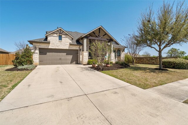 100 Adorno Ln, Georgetown, TX 78628 - view of front of house featuring stone siding, concrete driveway, and an attached garage