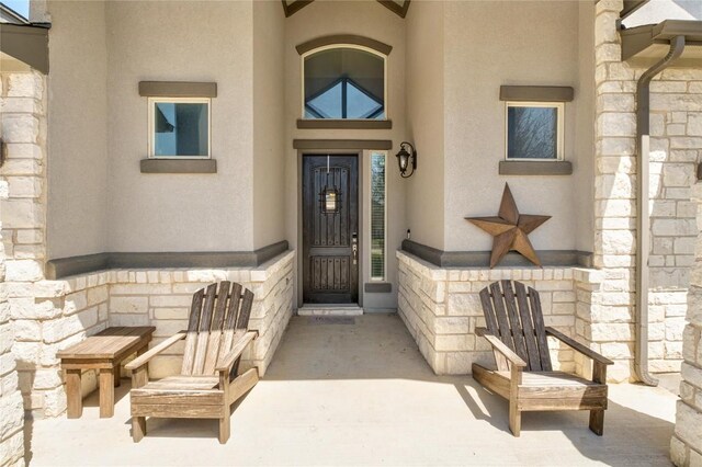 100 Adorno Ln, Georgetown, TX 78628 - property entrance with stone siding and stucco siding