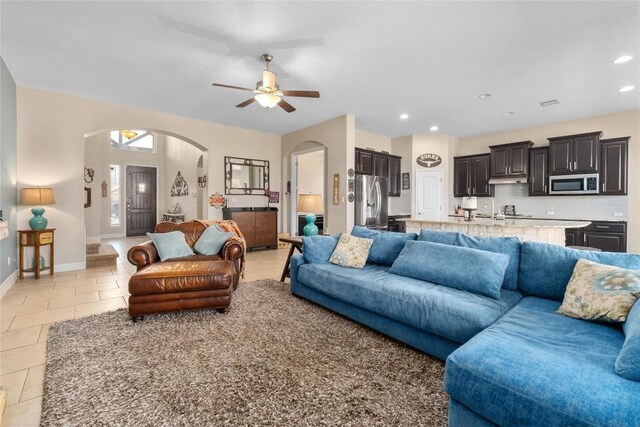 100 Adorno Ln, Georgetown, TX 78628 - living area with arched walkways, a ceiling fan, baseboards, light tile patterned floors, and recessed lighting