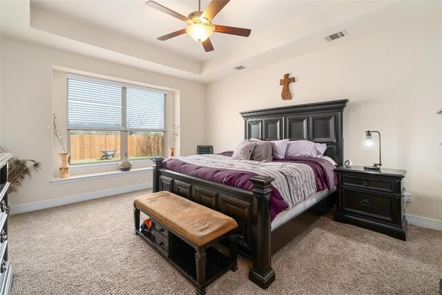 100 Adorno Ln, Georgetown, TX 78628 - bedroom featuring carpet flooring, a tray ceiling, baseboards, and a ceiling fan