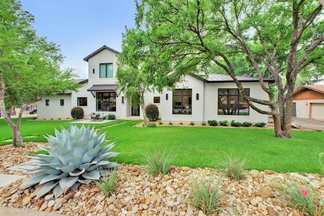 4704 Timberline Dr, Austin, TX 78746 - view of front of house featuring a standing seam roof, metal roof, and stucco siding