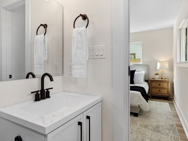 5416 Coventry Ln, Austin, TX 78723 - bathroom with vanity, wood finished floors, and ensuite bathroom