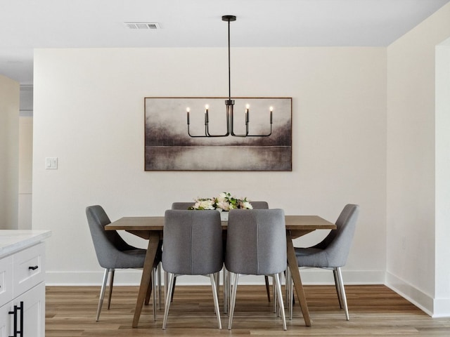 5416 Coventry Ln, Austin, TX 78723 - dining room featuring light wood-style flooring, baseboards, and a chandelier
