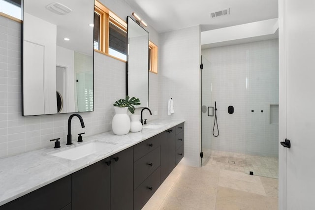 1411 Haskell St, Austin, TX 78702 - full bath with double vanity, a stall shower, tasteful backsplash, and tile walls