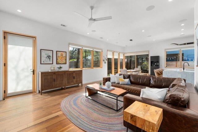1411 Haskell St, Austin, TX 78702 - living area featuring light wood-style floors, a ceiling fan, and recessed lighting