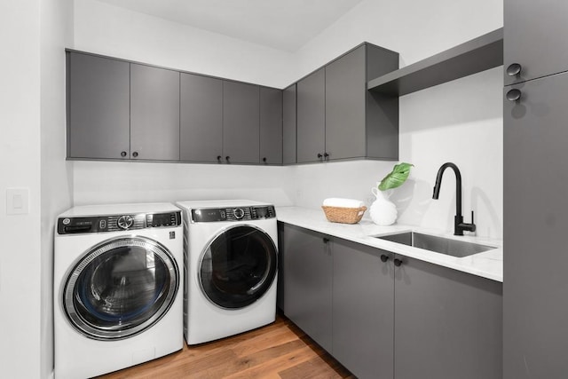1411 Haskell St, Austin, TX 78702 - laundry area with independent washer and dryer, cabinet space, and wood finished floors