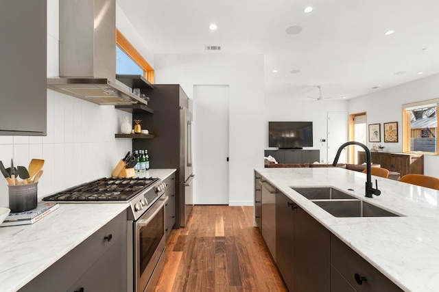 1411 Haskell St, Austin, TX 78702 - kitchen featuring exhaust hood, appliances with stainless steel finishes, dark wood-style floors, open shelves, and modern cabinets
