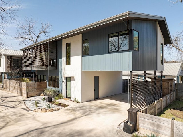 1411 Haskell St, Austin, TX 78702 - contemporary house with driveway, stucco siding, and a carport