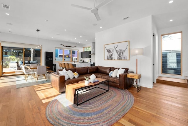 1411 Haskell St, Austin, TX 78702 - living room featuring light wood finished floors, ceiling fan, plenty of natural light, and recessed lighting