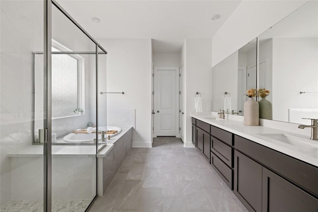 1005 Trevi Fontana, Leander, TX 78641 - bathroom with a garden tub, double vanity, a shower stall, and marble finish floors