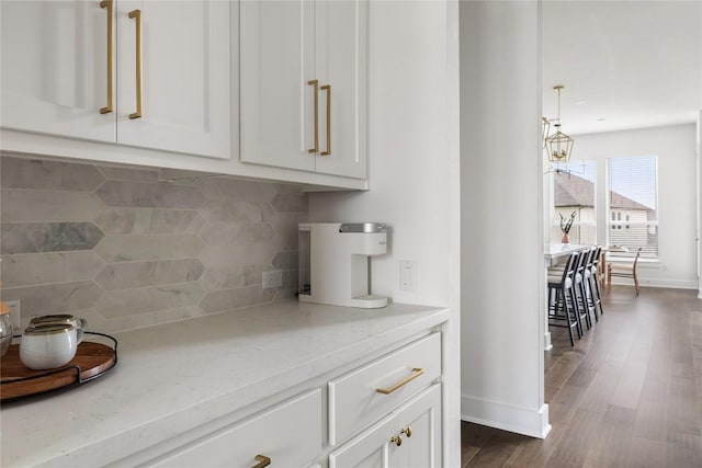 1005 Trevi Fontana, Leander, TX 78641 - kitchen featuring white cabinets, backsplash, dark wood finished floors, and a chandelier