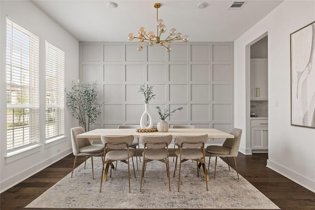 1005 Trevi Fontana, Leander, TX 78641 - dining area featuring a chandelier, dark wood finished floors, and a decorative wall