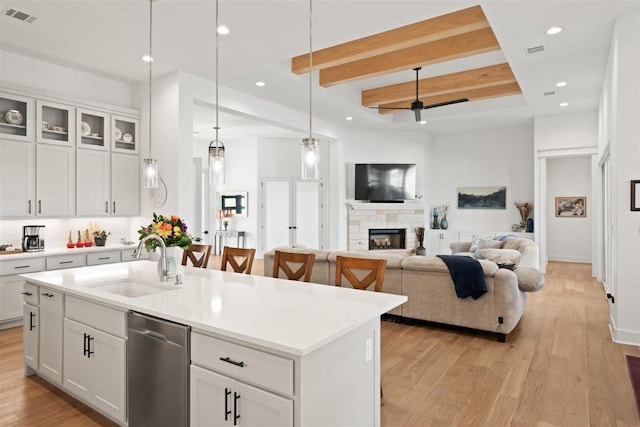 425 Private Road 915, Georgetown, TX 78633 - kitchen with light wood finished floors, visible vents, stainless steel dishwasher, a sink, and beam ceiling