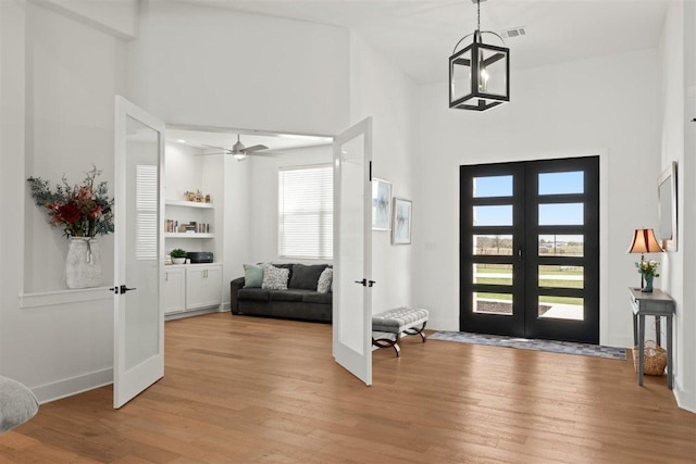 425 Private Road 915, Georgetown, TX 78633 - foyer entrance featuring light wood-type flooring, a high ceiling, ceiling fan, and french doors