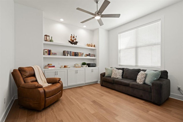 425 Private Road 915, Georgetown, TX 78633 - sitting room featuring light wood-style flooring, built in shelves, baseboards, and ceiling fan