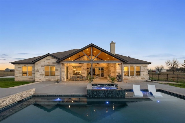 425 Private Road 915, Georgetown, TX 78633 - rear view of house with stone siding, a fenced in pool, and an in ground hot tub