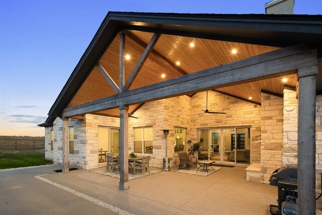 425 Private Road 915, Georgetown, TX 78633 - rear view of property with stone siding, fence, a ceiling fan, outdoor dining space, and a patio