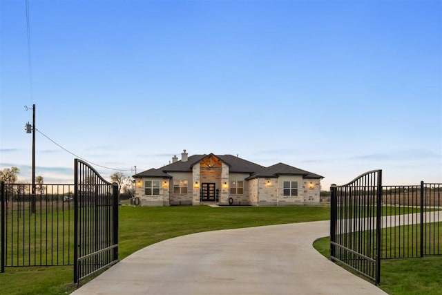 425 Private Road 915, Georgetown, TX 78633 - view of front of home with a front lawn, a gate, stone siding, fence, and curved driveway