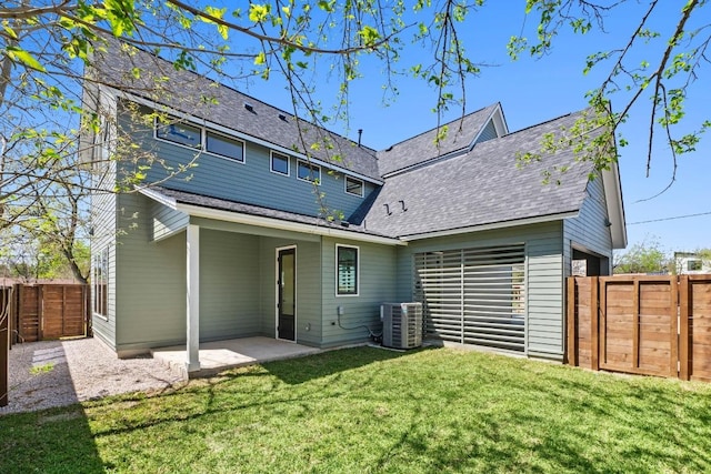 710 Philco Dr, Austin, TX 78745 - rear view of property featuring cooling unit, a fenced backyard, a shingled roof, a patio, and a yard