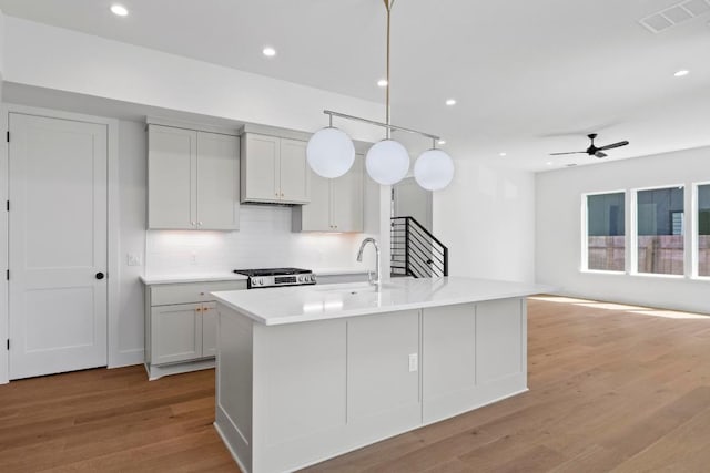 710 Philco Dr, Austin, TX 78745 - kitchen with visible vents, light wood-style flooring, ceiling fan, a sink, and stove