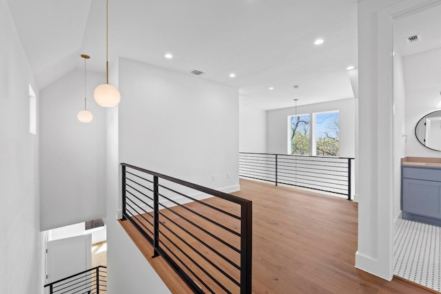 710 Philco Dr, Austin, TX 78745 - corridor with an upstairs landing, wood finished floors, recessed lighting, baseboards, and lofted ceiling