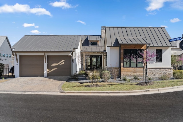 316 Hidden Beacon Bnd, Lakeway, TX 78738 - view of front of house with a standing seam roof, an attached garage, metal roof, and driveway