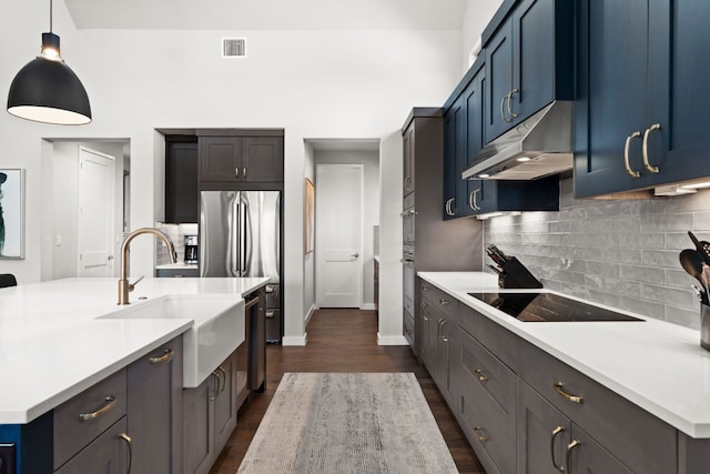 316 Hidden Beacon Bnd, Lakeway, TX 78738 - kitchen featuring under cabinet range hood, a sink, stainless steel appliances, and light countertops