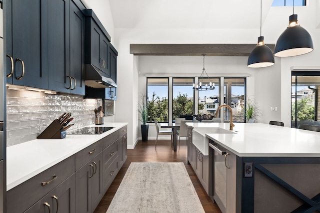 316 Hidden Beacon Bnd, Lakeway, TX 78738 - kitchen with black electric cooktop, light countertops, dark wood-style flooring, backsplash, and dishwasher