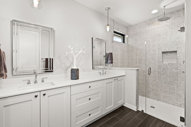 316 Hidden Beacon Bnd, Lakeway, TX 78738 - bathroom featuring a stall shower, double vanity, and wood tiled floors