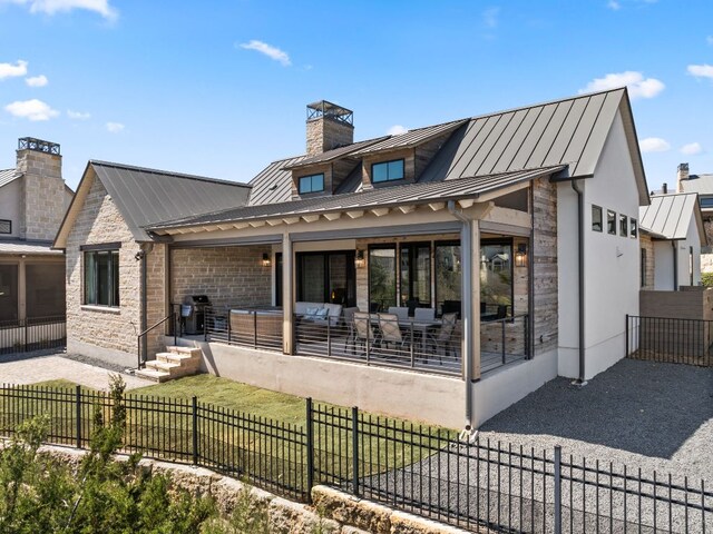 316 Hidden Beacon Bnd, Lakeway, TX 78738 - rear view of property with a standing seam roof, a metal roof, a chimney, and stone siding