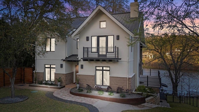 1905 Big Horn Dr, Austin, TX 78734 - view of front of property with a balcony, a standing seam roof, stucco siding, and metal roof