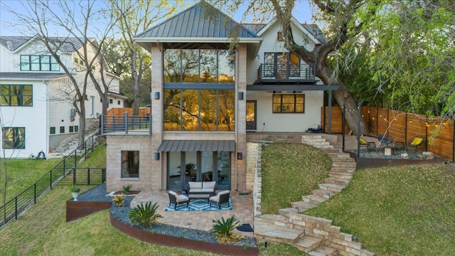 1905 Big Horn Dr, Austin, TX 78734 - rear view of house featuring a balcony, a patio area, stairs, an outdoor living space, and a standing seam roof