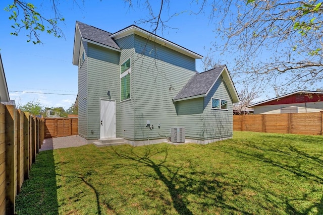 4525 S 3rd St, Austin, TX 78745 - rear view of property featuring a shingled roof and a fenced backyard