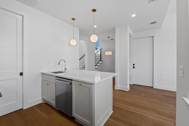4525 S 3rd St, Austin, TX 78745 - kitchen featuring dishwasher, dark wood finished floors, decorative light fixtures, light stone countertops, and recessed lighting