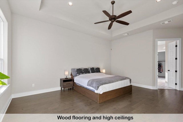 145 Gaston Dr, Bastrop, TX 78602 - bedroom with visible vents, wood finished floors, a tray ceiling, and recessed lighting