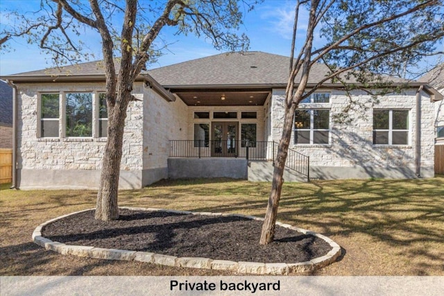 145 Gaston Dr, Bastrop, TX 78602 - back of property with a yard and stone siding
