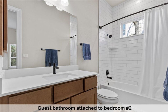 145 Gaston Dr, Bastrop, TX 78602 - bathroom with toilet, vanity, shower / tub combo with curtain, and plenty of natural light