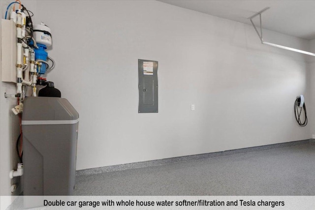 145 Gaston Dr, Bastrop, TX 78602 - garage with baseboards and electric panel