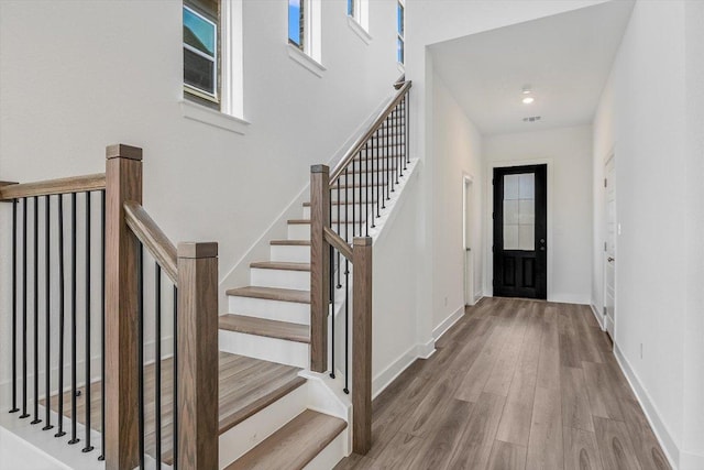1405 S Brook Dr, Leander, TX 78641 - entryway featuring wood finished floors, healthy amount of natural light, stairs, and a towering ceiling
