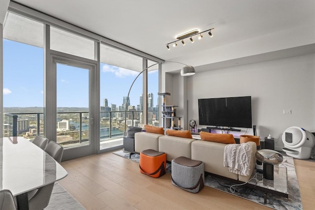 44 E Ave Unit 3402, Austin, TX 78701 - living room featuring wood finished floors and a wall of windows