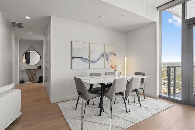 44 E Ave Unit 3402, Austin, TX 78701 - dining area featuring healthy amount of natural light, floor to ceiling windows, wood finished floors, recessed lighting, and baseboards