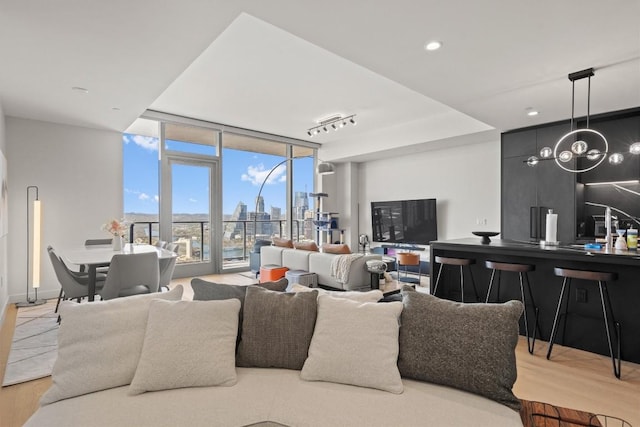 44 E Ave Unit 3402, Austin, TX 78701 - living area featuring floor to ceiling windows, wood finished floors, and recessed lighting