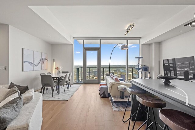 44 E Ave Unit 3402, Austin, TX 78701 - living area with floor to ceiling windows and wood finished floors